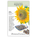 Seed packet for Botanical Interests Mongolian Giant sunflower seeds, featuring a large illustration of a sunflower, descriptive text, and a small bowl of sunflower seeds on a white background.