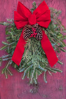 Cleatus Farms holiday evergreen swag styled flat on a rustic fireplace mantel