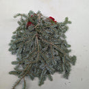 Back of a rustic Christmas swag made of fresh fir branches.
